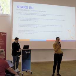 STARS EU project coordinator Stefanie Eul (at speakers' desk) and Vice-Rector for Studies, Teaching and Internationalisation Prof. Dr. Annika Maschwitz (on the photo with microphone) explained the project structures behind STARS EU. (Copyright HSB-Meike Mossig).