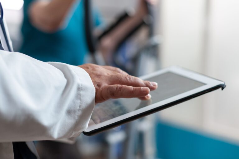 A healthcare professional using a digital tablet